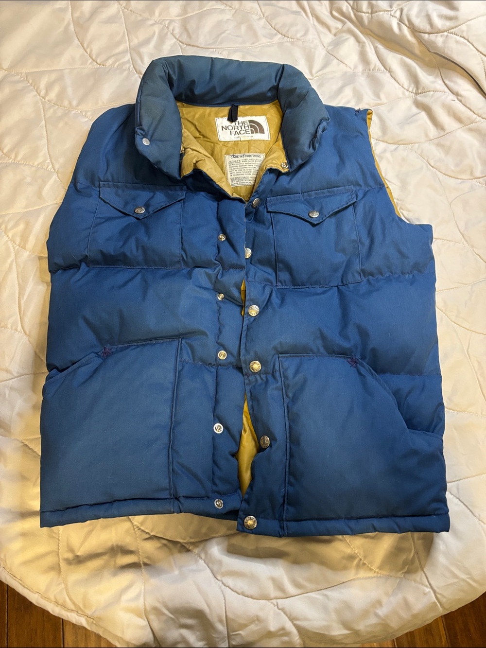 The North Face Blue Puffer Vest with Tan Lining